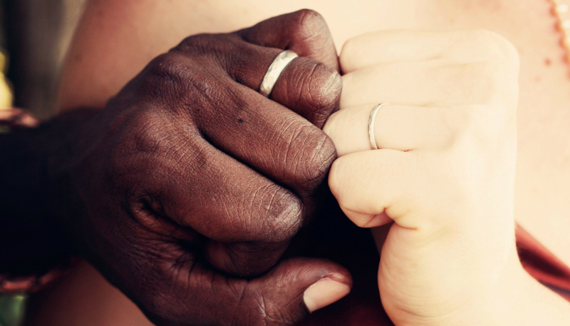 Two people holding hands as a symbol of support, connection, and healing in a relationship.