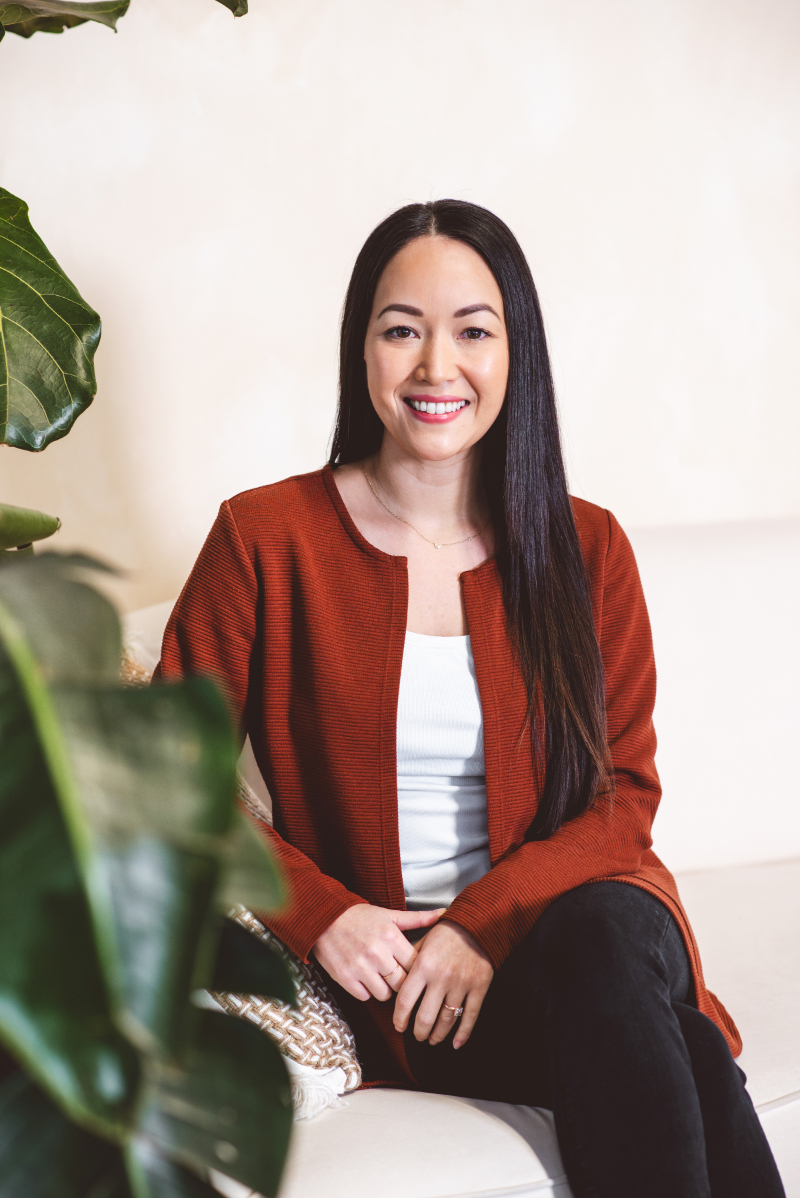 Woman smiling confidently, representing setting boundaries in relationships and building self-esteem in a calm, supportive space