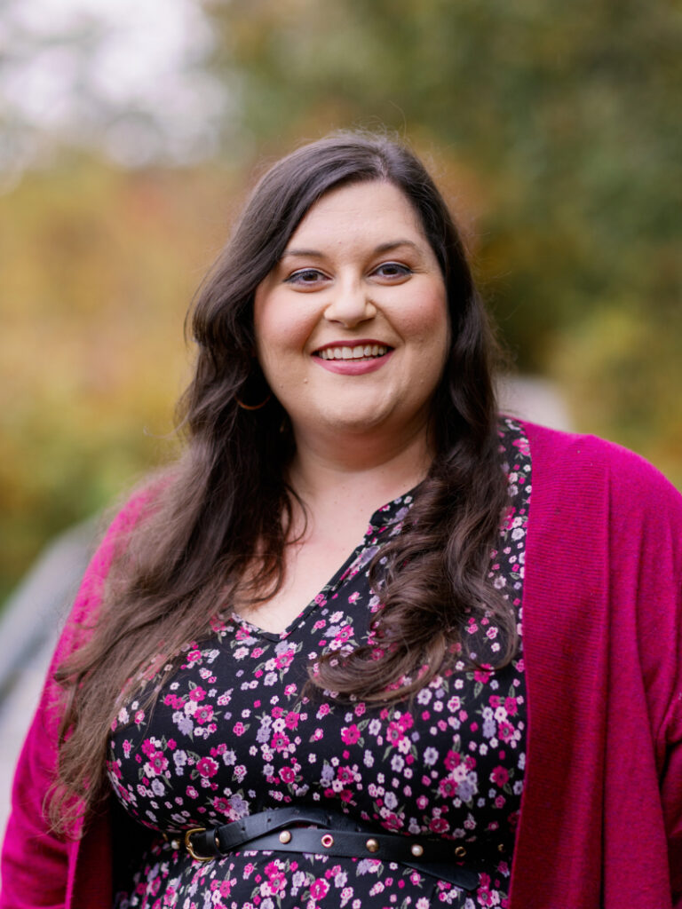 Smiling woman outdoors representing setting boundaries with coworkers and protecting emotional health in the workplace.