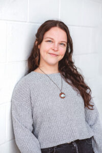 Woman smiling in a counselling setting, representing compassionate grief and loss counselling and emotional support.