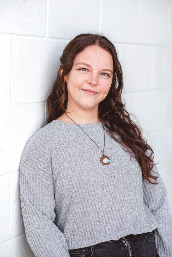 Woman smiling in a counselling setting, representing compassionate grief and loss counselling and emotional support.