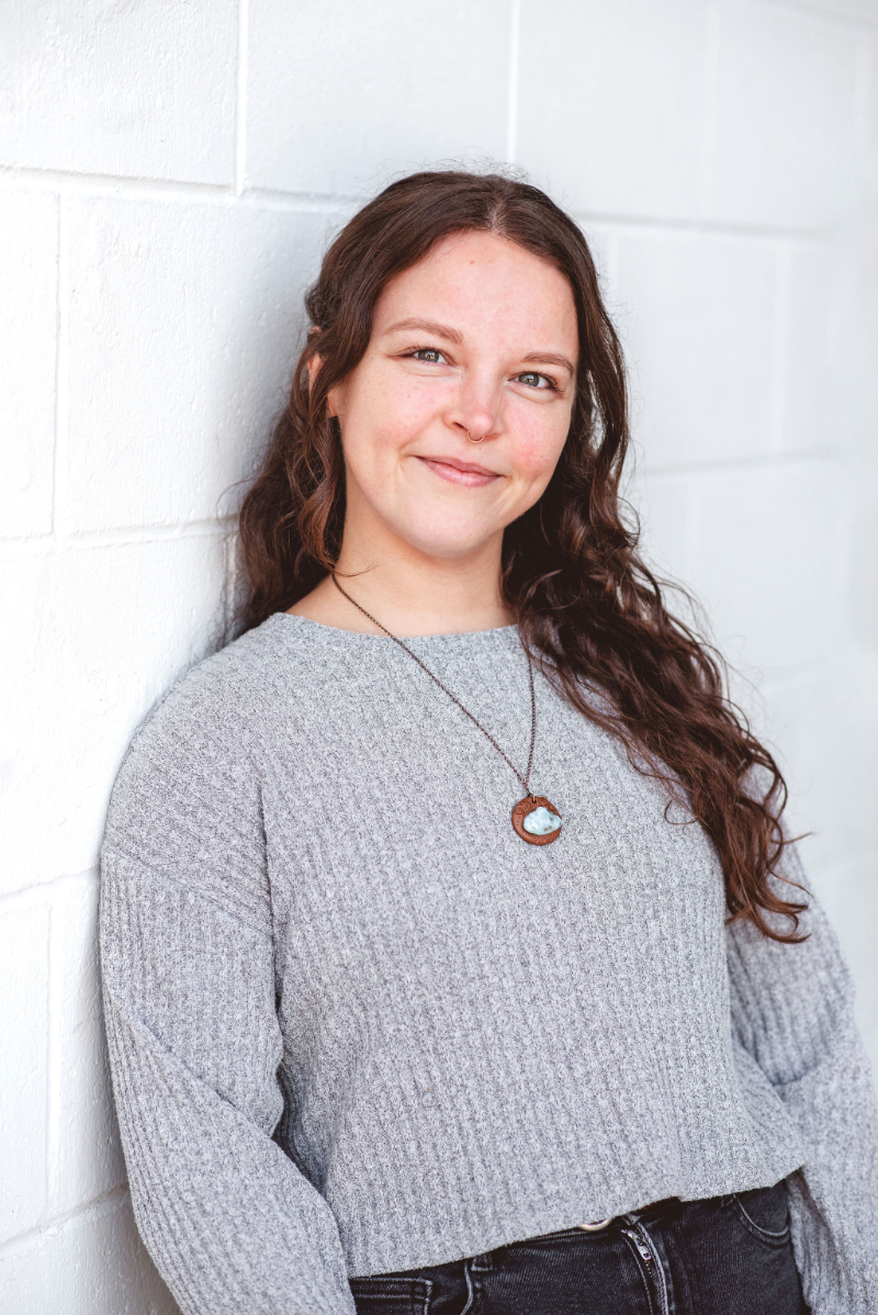 Woman smiling in a counselling setting, representing compassionate grief and loss counselling and emotional support.