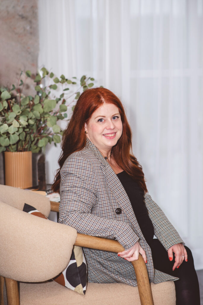 Woman smiling in a welcoming counselling space focused on building healthy relationship communication skills.