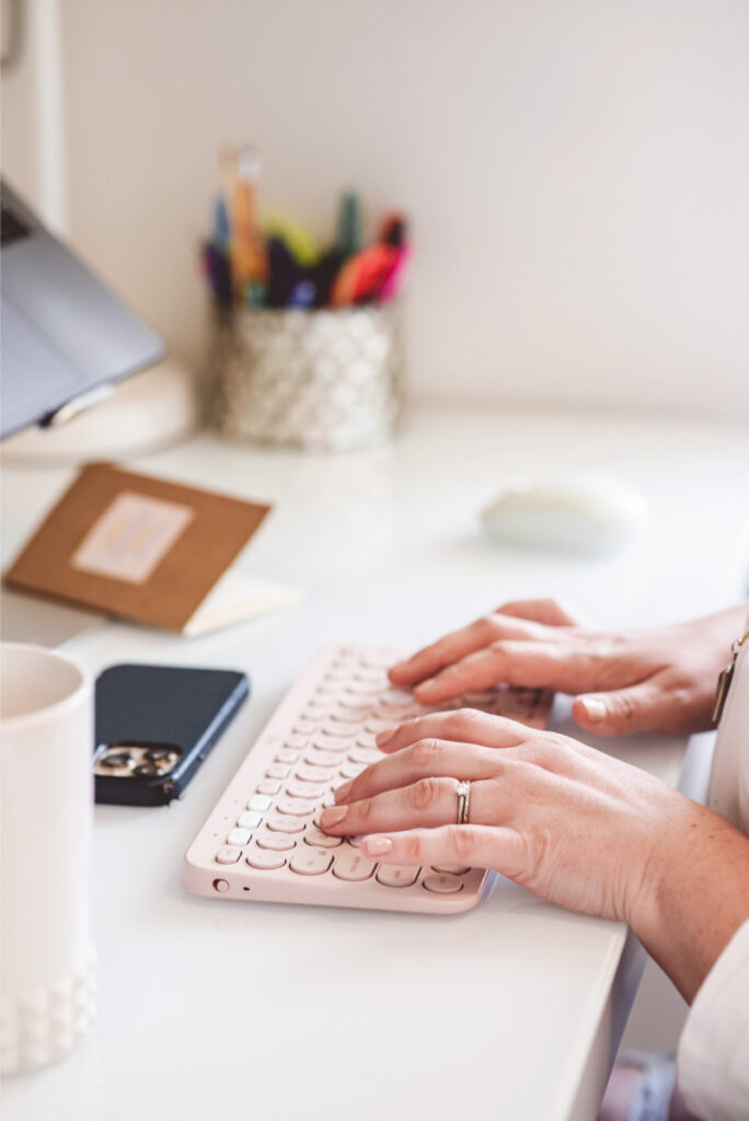 Person typing at a desk while researching information about supporting a loved one with an eating disorder.